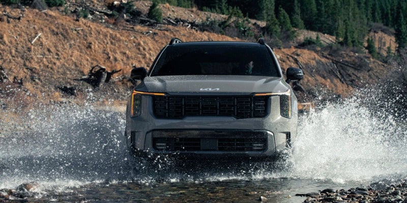 Kia Sorento Driving Through Stream in Mountains